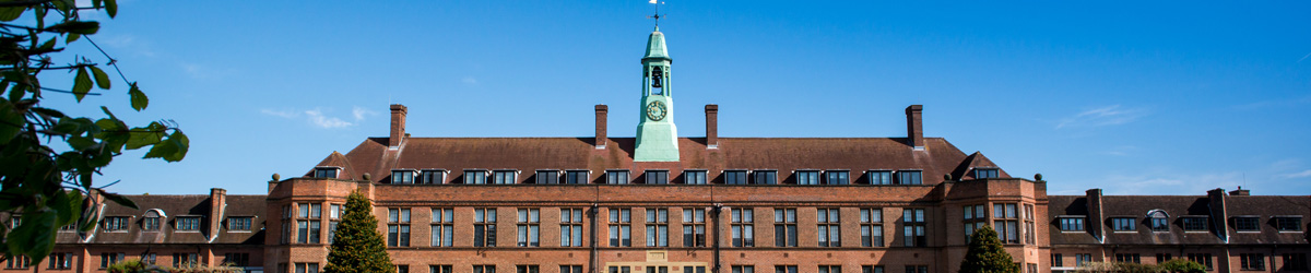 Photo of the HCA building under a blue sky